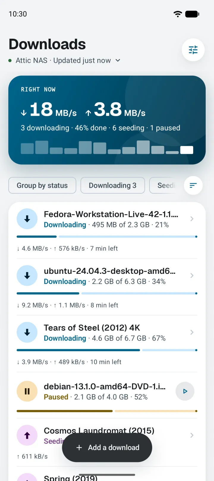 The Downloads screen: 18 MB/s down and 3.8 MB/s up, a speed chart, and a list of downloads with their progress.